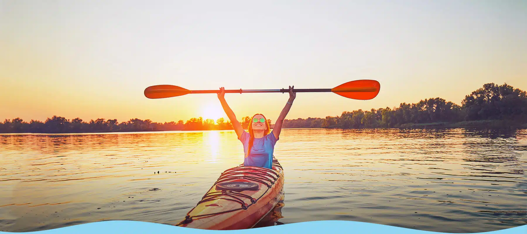 Woman Kayaking at Sunset