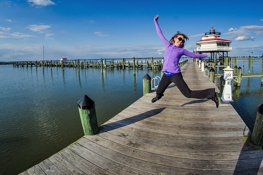 Woman happy jump on dock